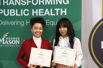 Briana and Ashley Dawson holding their Delta Omega Honorary Society Certificates