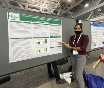 Image of a College of Public Health student standing in front of her research poster at the APHA annual meeting. 